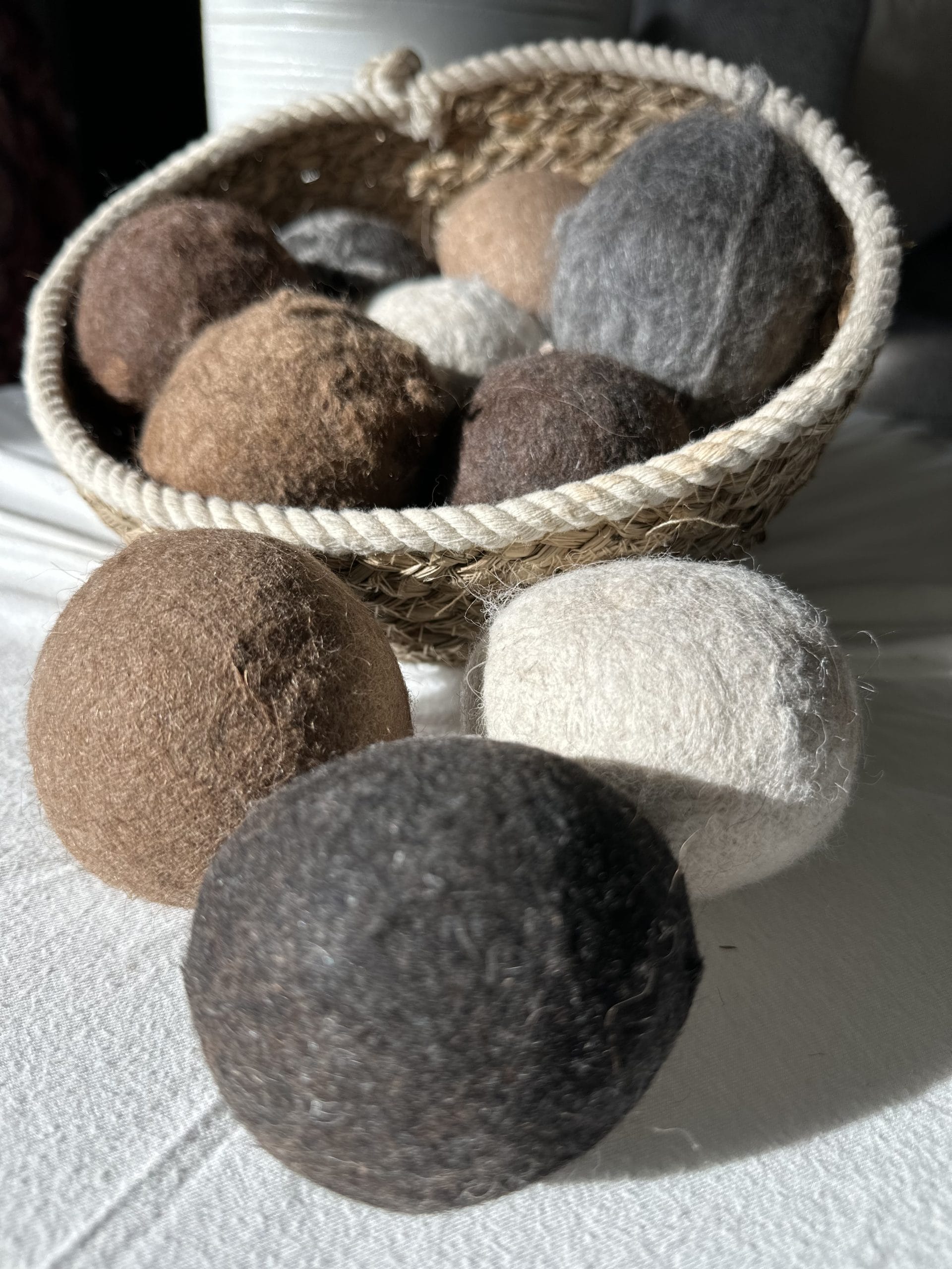 Felted Dryer Balls in a basket on a table.