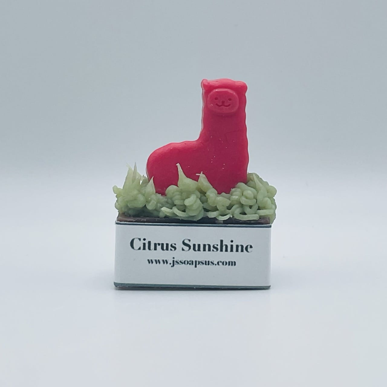 A red llama in a box with the words Locally-sourced Soap citrus sunshine.