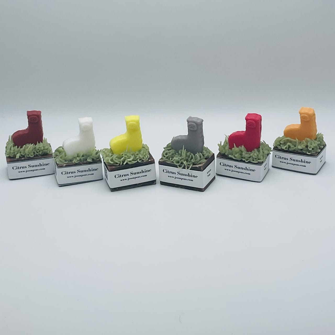 A group of Locally-sourced Soaps with different colors on top of them.