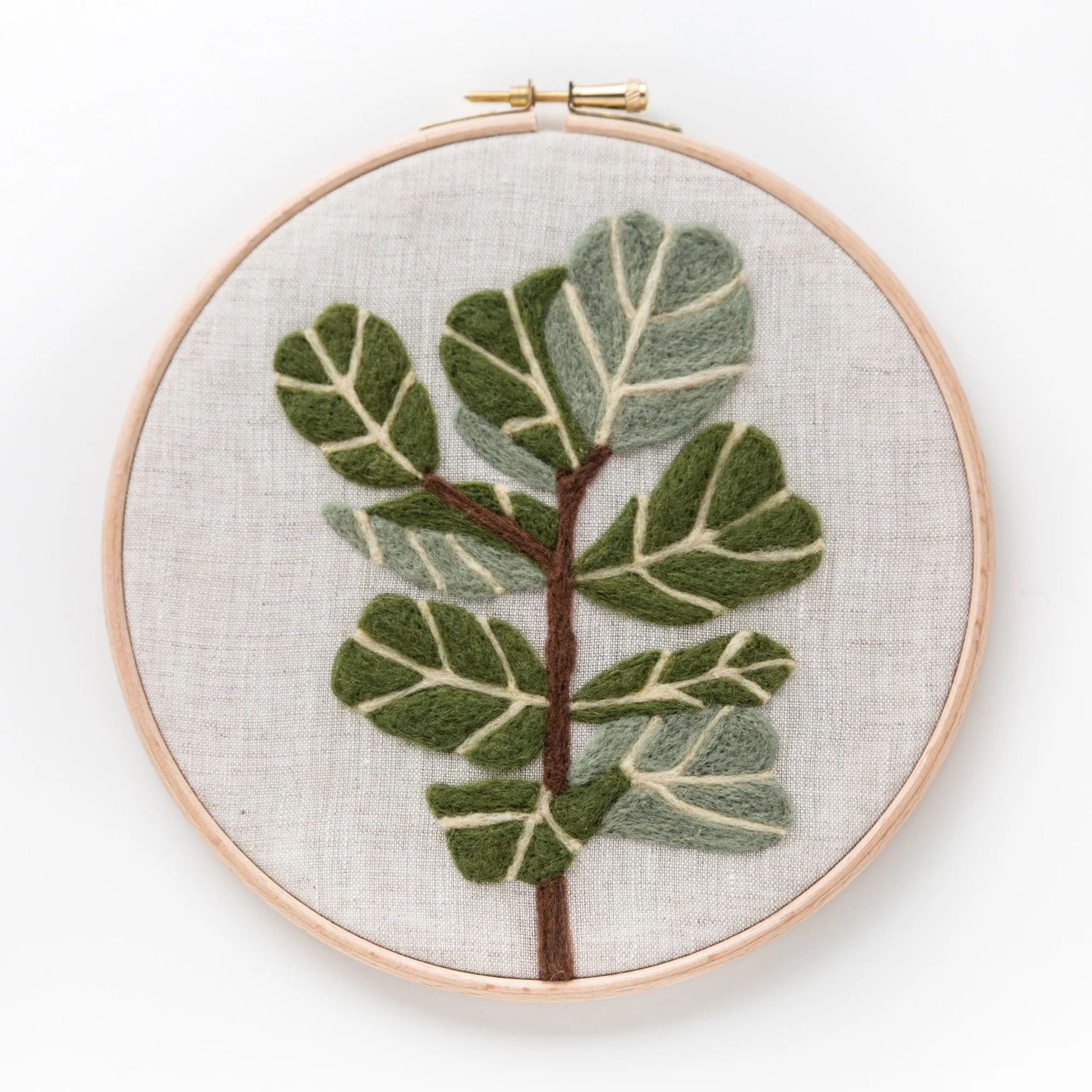 A Fiddle-Leaf Fig Needle Felting Kit embroidered on a hoop.