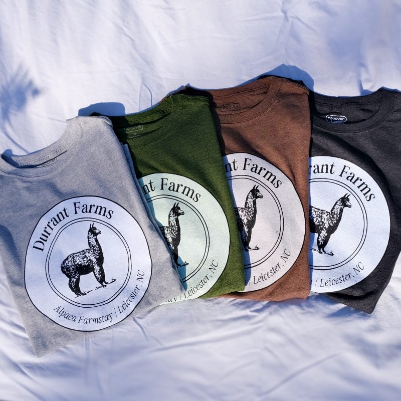 Four Durrant Farm T-shirts with photo of a llama on them.