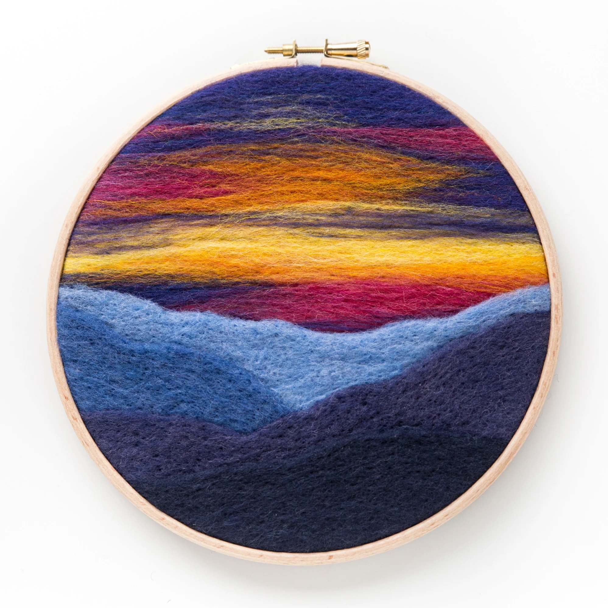 A Mountain Sunset Needle Felting Kit in a hoop.