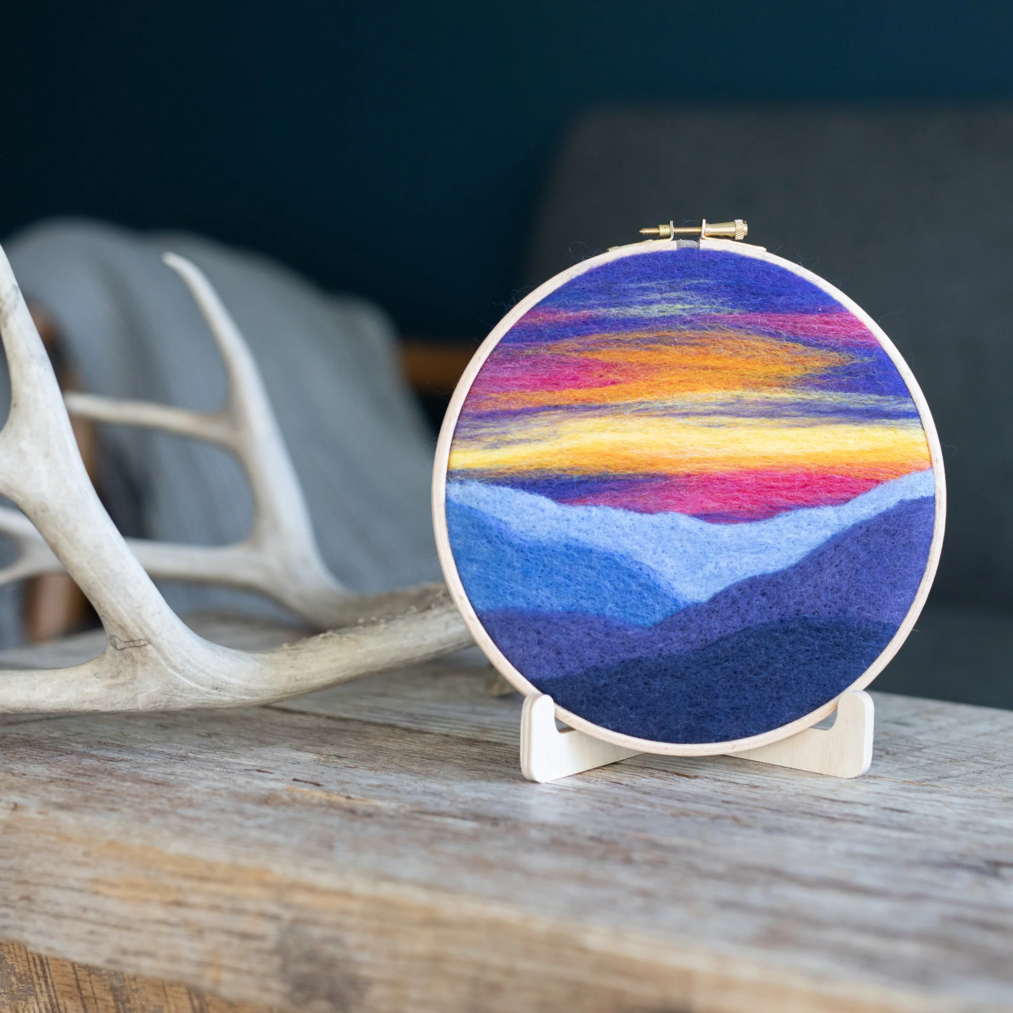 A Mountain Sunset Needle Felting Kit with a colorful sunset on it.