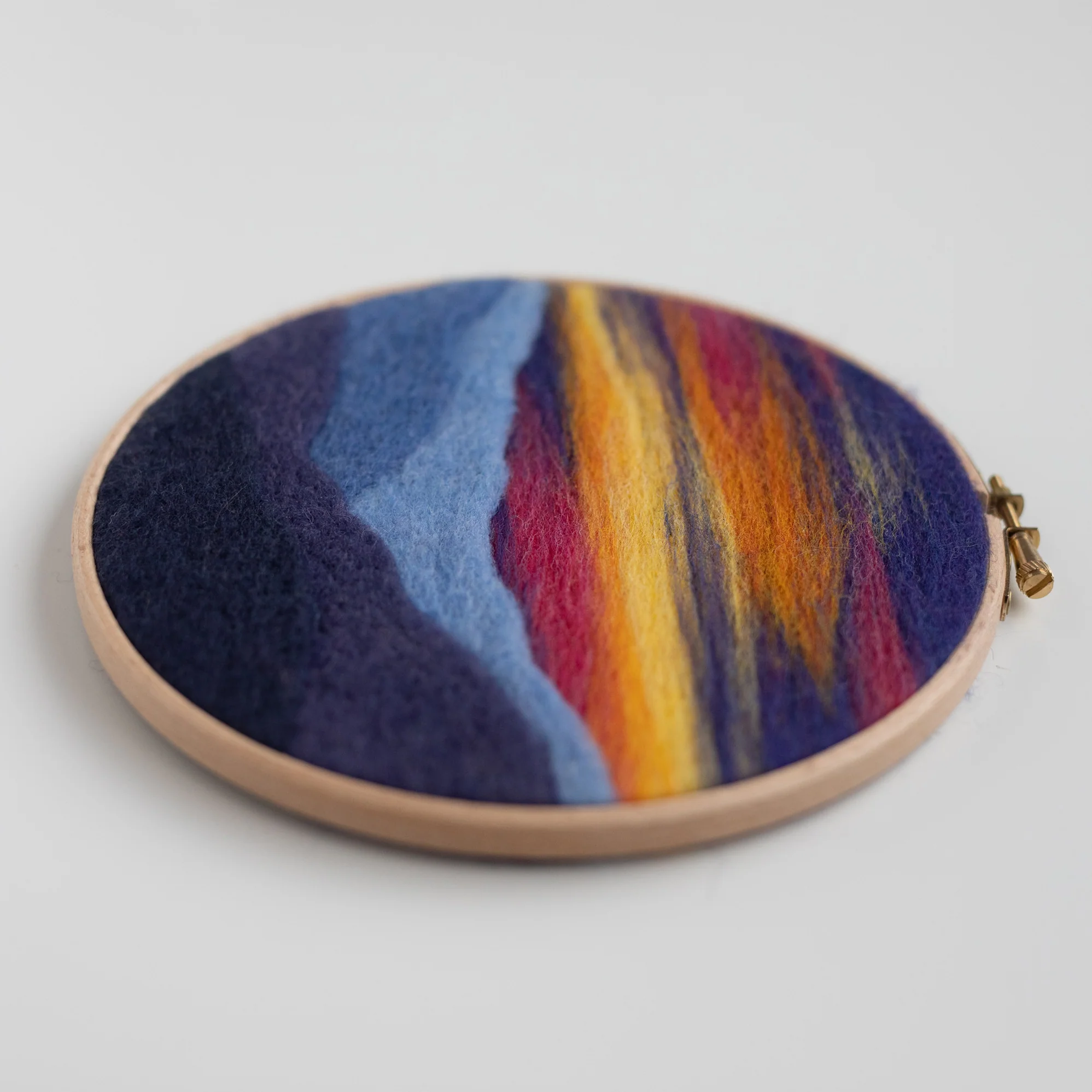 A colorful Mountain Sunset Needle Felting Kit with a zipper.